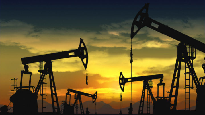 oil field and pump jack with sunset