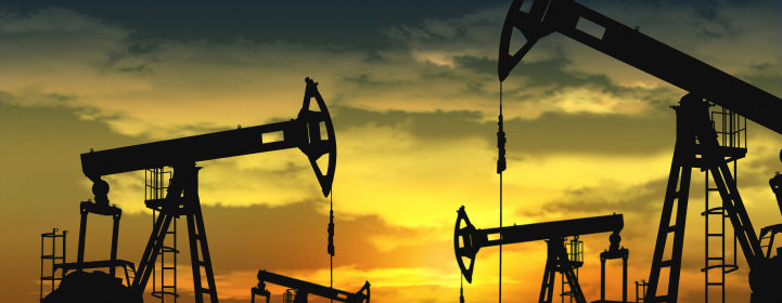 oil field and pump jack with sunset